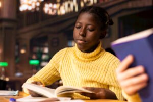 Revision Guide - female student reading from a opened book